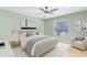 Comfortable bedroom features a ceiling fan, hardwood flooring, and natural light from a window at 3285 Majestic Oak Dr, St Cloud, FL 34771