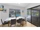Bright dining area features a view of the pool, hardwood floors, and contemporary furnishings at 3285 Majestic Oak Dr, St Cloud, FL 34771