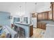 Well-lit kitchen features bar seating, stainless appliances, stone countertops, and a view of the backyard pool at 3285 Majestic Oak Dr, St Cloud, FL 34771