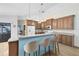 Well-lit kitchen with ample cabinet space, hardwood floors, a breakfast bar, and modern appliances at 3285 Majestic Oak Dr, St Cloud, FL 34771