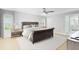 Comfortable bedroom features a ceiling fan, hardwood flooring, and an ensuite bathroom with a bathtub at 3285 Majestic Oak Dr, St Cloud, FL 34771