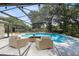 Screened-in pool area with lounge seating and tropical landscaping at 3285 Majestic Oak Dr, St Cloud, FL 34771