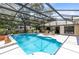View of pool with lounge seating, dining and RV in background at 3285 Majestic Oak Dr, St Cloud, FL 34771