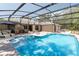 View of pool with steps, lounge seating and spa in background at 3285 Majestic Oak Dr, St Cloud, FL 34771