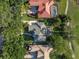 Aerial view of home with red car, golf course, and screened pool area at 3352 Park Grove Ct, Longwood, FL 32779