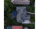 Aerial view of a home with dark grey roof, screened in pool, and beautiful landscaping at 3352 Park Grove Ct, Longwood, FL 32779