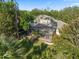 Aerial view of home with screened in pool surrounded by mature tropical landscaping at 3352 Park Grove Ct, Longwood, FL 32779