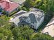 Aerial view of beautiful home with grey tile roof and green foliage at 3352 Park Grove Ct, Longwood, FL 32779