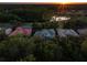 Aerial view of a community with mature trees, ponds and single Gathering homes at sunset at 3352 Park Grove Ct, Longwood, FL 32779