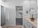 Bright bathroom featuring a double vanity and tiled floors, flowing into a bedroom at 3352 Park Grove Ct, Longwood, FL 32779