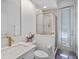 Bathroom featuring a walk-in shower with gold trim, modern white vanity, and door to the outside at 3352 Park Grove Ct, Longwood, FL 32779