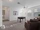 Bright bonus room showcasing multiple windows and a ceiling fan, with carpeted floors at 3352 Park Grove Ct, Longwood, FL 32779