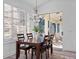 Dining area with wooden table, seating for six and natural light coming from sliding glass doors at 3352 Park Grove Ct, Longwood, FL 32779