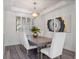 Dining room featuring a modern chandelier and a wood table with upholstered chairs at 3352 Park Grove Ct, Longwood, FL 32779