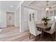 Dining room featuring a modern light fixture, wainscoting, and a wood table with upholstered chairs at 3352 Park Grove Ct, Longwood, FL 32779