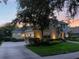 Spacious home with a three-car garage, landscaped yard, and basketball hoop at 3352 Park Grove Ct, Longwood, FL 32779