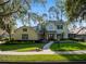 Charming two-story home with a landscaped front yard, illuminated walkway and welcoming double-door entrance at 3352 Park Grove Ct, Longwood, FL 32779
