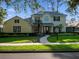 Charming two-story home featuring lush landscaping, a walkway, and a well-manicured lawn at 3352 Park Grove Ct, Longwood, FL 32779