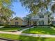 Charming two-story home with a landscaped front yard, illuminated walkway and welcoming double-door entrance at 3352 Park Grove Ct, Longwood, FL 32779