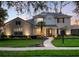 Charming two-story home with a landscaped front yard, illuminated walkway and welcoming double-door entrance at 3352 Park Grove Ct, Longwood, FL 32779