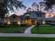 Charming two-story home with a landscaped front yard, illuminated walkway and welcoming double-door entrance at 3352 Park Grove Ct, Longwood, FL 32779