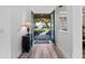 Bright foyer with wood flooring and views of the landscaped front yard through glass panelled front doors at 3352 Park Grove Ct, Longwood, FL 32779