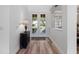 Bright foyer with wood flooring and views of the landscaped front yard through glass panelled front doors at 3352 Park Grove Ct, Longwood, FL 32779