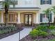 Inviting front entrance with stone accents, palm trees, and a walkway leading to the double doors at 3352 Park Grove Ct, Longwood, FL 32779