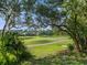 Scenic view of a lush green golf course and a picturesque lake with a single-Gathering home in the background at 3352 Park Grove Ct, Longwood, FL 32779