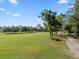Scenic view of lush green golf course under blue sky at 3352 Park Grove Ct, Longwood, FL 32779