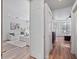 Bright hallway view showcasing open floor plan and light filled living room and bedroom area with wood flooring at 3352 Park Grove Ct, Longwood, FL 32779