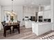 Spacious open concept kitchen featuring an island, modern appliances, and dining area at 3352 Park Grove Ct, Longwood, FL 32779