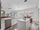 Modern kitchen with white cabinets, stainless steel appliances, and a center island with granite countertop at 3352 Park Grove Ct, Longwood, FL 32779