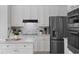 Bright kitchen featuring white cabinets, stainless appliances, and a center island with counter seating at 3352 Park Grove Ct, Longwood, FL 32779
