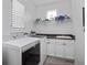 Laundry room featuring a washer and dryer, white cabinets, ample storage space, and a window for natural light at 3352 Park Grove Ct, Longwood, FL 32779