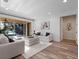 Bright living room with two sofas, a plush rug, and sliding glass doors offering pool views at 3352 Park Grove Ct, Longwood, FL 32779