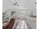 Bright open concept living area featuring a leather couch, armchairs, and lots of natural light at 3352 Park Grove Ct, Longwood, FL 32779