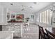 Open-concept living area with white cabinets, stainless steel appliances and dining area at 3352 Park Grove Ct, Longwood, FL 32779