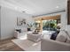 Bright living room with two sofas, a plush rug, and sliding glass doors with view to the pool at 3352 Park Grove Ct, Longwood, FL 32779