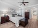 Bright main bedroom with wood-look floors, tray ceiling, and ensuite bath at 3352 Park Grove Ct, Longwood, FL 32779