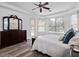 Spacious main bedroom with wood-look floors, tray ceiling, and ensuite bath at 3352 Park Grove Ct, Longwood, FL 32779