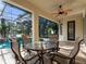 Relaxing screened lanai with a ceiling fan and comfortable seating area overlooking the pool at 3352 Park Grove Ct, Longwood, FL 32779