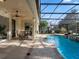 Covered patio with ceiling fan and a view of the beautiful pool and landscaped backyard at 3352 Park Grove Ct, Longwood, FL 32779