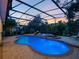 Covered outdoor pool featuring an integrated jacuzzi and beautiful twilight sky at 3352 Park Grove Ct, Longwood, FL 32779