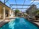 Relax in this sparkling blue pool and spa within a screened-in enclosure at 3352 Park Grove Ct, Longwood, FL 32779