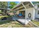 Covered back porch with seating and a view to the backyard at 3714 Paige St, Port Orange, FL 32127
