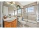 This tiled bathroom has a shower and bath combination with glass doors at 3714 Paige St, Port Orange, FL 32127