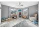 This charming bedroom has neutral colors, wood-look floors, and two bright windows at 3714 Paige St, Port Orange, FL 32127