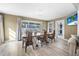 Bright dining room features a large wood table, seating for six, and views to the fenced yard at 3714 Paige St, Port Orange, FL 32127