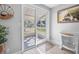 Bright entryway featuring white wood-look flooring, decorative accents, and a view to the screened porch at 3714 Paige St, Port Orange, FL 32127